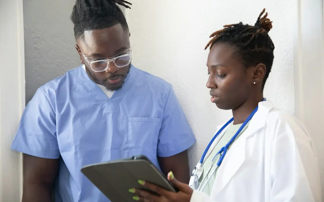 Two clinicians reviewing information together on a tablet